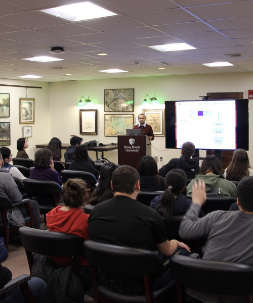 Dr. Kirane at podium speaking to attendees